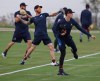 Atlanta Braves pitchers, from left, Shane Greene, Mike Foltynewicz and Max Fried loosen up at spring training baseball camp in North Port, Fla., Wednesday, Feb. 12, 2020. (Curtis Compton/Atlanta Journal-Constitution via AP)