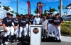 Atlanta Braves Chairman Terry McGuirk, center, and members of the Atlanta Braves baseball team honor baseball Hall of Famer Hank Aaron, third from right, front, with a street named after him outside CoolToday Park, the spring training baseball facility of the Braves, in North Port, Fla., Tuesday, Feb. 18, 2020 (Curtis Compton/Atlanta Journal-Constitution via AP)
