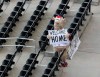 Atlanta Braves mascot Blooper is alone in the seats void of fans while welcoming the Atlanta Braves home for their home-opener baseball game against the Tampa Bay Rays, during the first inning Wednesday, July 29, 2020, in Atlanta. (Curtis Compton/Atlanta Journal-Constitution via AP)