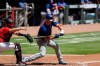 New York Mets' Pete Alonso, right, strikes out in the fifth inning of a baseball game on Sunday, Aug. 2, 2020, in Atlanta. (AP Photo/Brynn Anderson)