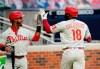 Philadelphia Phillies' Didi Gregorius, right, celebrates with Philadelphia Phillies' Jean Segura, left, after scoring on a solo home run during the third inning of a baseball game against the Atlanta Braves, Sunday, Aug. 23, 2020, in Atlanta. (AP Photo/Brynn Anderson)