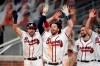 Atlanta Braves shortstop Dansby Swanson, center, celebrates after hitting a walk-off two-run home run in the ninth inning of a baseball game against the Washington Nationals Monday, Aug. 17, 2020, in Atlanta. (AP Photo/John Bazemore)