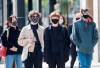 People wear face masks as they wait to cross a street in Montreal, Monday, September 21, 2020, as the COVID-19 pandemic continues in Canada and around the world. THE CANADIAN PRESS/Graham Hughes