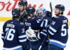 CP
Goaltender Eric Comrie is congratulated by his teammates after earning his first NHL shutout in a 4-0 win over the Philadelphia Flyers on Wednesday. (John Woods / The Canadian Press)