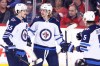CP
Kyle Connor (centre) celebrates his game-winning goal against Calgary Mark Scheifele (left) and Brenden Dillon. It was his second of the night. (Larry Mac Dougal / The Canadian Press)