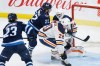 CP
Austin Poganski puts in a rebound against Ilya Konovalov during the second period on Wednesday. The Jets would go on to win the game 5-1. (John Woods / The Canadian Press)