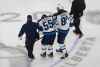 Winnipeg Jets' Mark Scheifele is helped off the ice after being injured against the Calgary Flames during first period NHL qualifying round game action in Edmonton, on Saturday August 1, 2020. (Jason Franson / The Canadian Press)