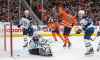 Winnipeg Jets goalie Connor Hellebuyck (37) is scored on as Edmonton Oilers' Leon Draisaitl (29) celebrates the goal during second period NHL action in Edmonton, Saturday, Feb. 29, 2020. (Jason Franson / The Canadian Press)