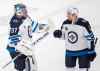 CP
Winnipeg Jets goaltender Connor Hellebuyck celebrates with teammate Dylan DeMelo after defeating the Montreal Canadiens in an NHL hockey game in Montreal, Saturday, April 10, 2021.  (Graham Hughes / The Canadian Press)
