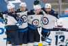 Winnipeg Jets left wing Nikolaj Ehlers (27) celebrates his goal with teammates Andrew Copp (9), Neal Pionk (4), Mathieu Perreault (85) and Pierre-Luc Dubois (13) during third period NHL action against the Toronto Maple Leafs in Toronto on Saturday, March 13, 2021. (Frank Gunn / The Canadian Press)
