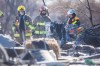 MIKAELA MACKENZIE / WINNIPEG FREE PRESS
Firefighters investigate at the scene of a fatal fire in a homeless encampment on Higgins Avenue in Winnipeg on Tuesday.