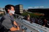 Cubs executive vice president of sales and marketing Colin Faulkner looks to the field from the Wrigley Rooftop before the Opening Day baseball game between the Chicago Cubs and the Milwaukee Brewers in Chicago, Friday, July 24, 2020, in Chicago. The Chicago Cubs open against the Milwaukee Brewers. In a normal year, that would mean a sellout crowd at Wrigley Field and jammed bars surrounding the famed ballpark. But in a pandemic-shortened season, it figures to be a different atmosphere. (AP Photo/Nam Y. Huh)