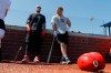 Cincinnati Reds' Tucker Barnhart, left, talks with Josh VanMeter during a workout at Grand Park, Friday, June 12, 2020, in Westfield, Ind. Proceeds from the event will go to Reviving Baseball in the Inner City of Indianapolis. (AP Photo/Darron Cummings)