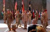 FILE - In this Sept. 14, 2019 file photo, U.S. Army Lt. Gen. Pat White, III Armored Corps Commanding General, second left, and Commanding General for U.S. Central Command Gen. Kenneth F. McKenzie Jr. center, take part in a transfer of authority ceremony at Union III, base in Baghdad, Iraq. On Sunday, Jan. 5, 2020, Iraq's parliament voted in favor of a resolution that calls for ending foreign military presence in the country two days after an Iranian general and a top commander were killed in a U.S. airstrike. The resolution specifically calls for ending an agreement in which Washington sent troops to Iraq more than four years ago to help in the fight against the Islamic State group. (AP Photo/Khalid Mohammed, File)