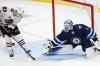 THE CANADIAN PRESS/John Woods
Winnipeg Jets goaltender Eric Comrie knocks the puck away from Chicago Blackhawks' Philipp Kurashev during his third start and third win of the season.