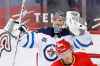 CP
Winnipeg Jets goalie Connor Hellebuyck, top, celebrates a 4-0 shutout over the Calgary Flames in Calgary on Wednesday. THE CANADIAN PRESS/Larry MacDougal