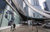 A pedestrian walks outside Rogers Place, home of the Edmonton Oilers, in Edmonton, Alta., on Thursday March 12, 2020. The NHL has suspended the 2019-20 season due to the COVID-19 pandemic. The federal government has made a move to try to help one of three Canadian markets become a hub city for the National Hockey League's resumption of play. THE CANADIAN PRESS/Jason Franson