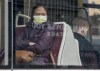 A woman wears a mask as she rides a TTC streetcar in Toronto on Friday, March 20, 2020. The gradual reopening of Canada's economy will not mean business as usual for the country's public transit agencies. THE CANADIAN PRESS/Frank Gunn