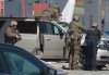 RCMP officers prepare to take a person into custody at a gas station in Enfield, N.S. on Sunday April 19, 2020. Police say the man who went on a murderous rampage through five Nova Scotia communities was likely using unlicensed firearms, and investigators are trying find out how he obtained illegal weapons. THE CANADIAN PRESS/Tim Krochak