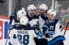 Winnipeg Jets right wing Logan Shaw (38) is congratulated by teammates Jansen Harkins (58), Nicholas Shore (21), Anthony Bitetto and Nathan Beaulieu (88) after scoring a goal on the Minnesota Wild in the third period of an NHL hockey game Saturday, Dec. 21, 2019, in St. Paul, Minn. (Andy Clayton-King / The Associated Press)