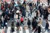 People wearing face masks to protect against the spread of the coronavirus cross a scramble intersection in Tokyo, Tuesday, March 9, 2021. (AP Photo/Koji Sasahara)