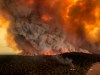 FILE - In this Monday, Dec. 30, 2019, aerial file photo, wildfires rage under plumes of smoke in Bairnsdale, Australia. U.S. officials said Tuesday, Jan. 7, 2020 they planning to send at least 100 more firefighters to Australia to join 159 already there battling blazes that have killed multiple people and destroyed thousands of homes. (Glen Morey via AP, File)