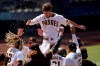 FILE - In this Aug. 27, 2020 file photo, San Diego Padres' Wil Myers, top, reacts after hitting a three-run walkoff home run to defeat the Seattle Mariners in a baseball game in San Diego. Wil Myers is back. While Manny Machado and Fernando Tatis Jr. have grabbed most of the attention on the playoff-bound Padres, Myers' comeback performance has also been instrumental in returning San Diego to postseason play for the first time since 2006. Myers is hitting .291 with 14 homers and 38 RBIs in 52 games. (AP Photo/Gregory Bull, File)