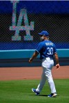 Los Angeles Dodgers manager Dave Roberts walks in the outfield during the restart of spring training Friday, July 3, 2020, in Los Angeles. (AP Photo/Mark J. Terrill)a