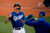 Los Angeles Dodgers' Enrique Hernandez, left, is congratulated after scoring on a single by Max Muncy during an intrasquad baseball game Wednesday, July 15, 2020, in Los Angeles. (AP Photo/Mark J. Terrill)