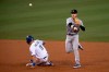 Colorado Rockies shortstop Trevor Story, right, turns a double play over the slide by Los Angeles Dodgers' A.J. Pollock during the second inning of a baseball game in Los Angeles, Friday, Sept. 4, 2020. Joc Pederson was out at first. (AP Photo/Kyusung Gong)