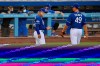 Los Angeles Dodgers manager Dave Roberts, left, talks with relief pitcher Blake Treinen during an intrasquad baseball game Wednesday, July 8, 2020, in Los Angeles. (AP Photo/Mark J. Terrill)