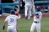 Los Angeles Dodgers' Enrique Hernandez, right, celebrates with Joc Pederson, front left, after hitting a three-run home run as Colorado Rockies catcher Elias Diaz, back left, looks away during the fourth inning of a baseball game in Los Angeles, Sunday, Aug. 23, 2020. (AP Photo/Alex Gallardo)