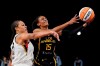 Los Angeles Sparks guard Brittney Sykes, right, shoots as Las Vegas Aces center Liz Cambage defends during the first half of a WNBA basketball game Friday, July 2, 2021, in Los Angeles. (AP Photo/Mark J. Terrill)