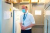 Sir Simon Stevens, the Chief Executive of the National Health Service in England, looks at the freezer facility at the Royal Free Hospital in London, Monday Dec. 7, 2020, during a visit to see preparations and meet staff who will be starting the coronavirus vaccination programme from Tuesday. (Dominic Lipinski/Pool via AP)