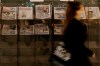 A pedestrian passes newspapers on display with front pages featuring images of members of the royal family, outside a shop in London, Wednesday, March 10, 2021. In countries with historic ties to Britain, allegations by Prince Harry and Meghan about racism within the royal family have raised questions about whether those nations want to be closely connected to Britain anymore after the couple's interview with Oprah Winfrey. (AP Photo/Kirsty Wigglesworth)