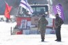 Land protectors stand on the closed train track on the ninth day of the blockade in Tyendinaga, near Belleville, Ont., on Friday Feb. 14, 2020, as they protest in solidarity with the Wet'suwet'en hereditary chiefs opposed to the LNG pipeline in northern British Columbia. THE CANADIAN PRESS/Lars Hagberg