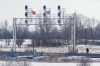 A protester walks on the closed train tracks near a train signal with Mohawk warrior and Sixth Nations flags on the twelfth day of the protest in Tyendinaga, near Belleville, Ontario, on Monday Feb.17, 2020, as they protest in solidarity with the Wet'suwet'en hereditary chiefs opposed to the LNG pipeline in northern British Columbia. THE CANADIAN PRESS/Lars Hagberg