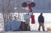 A protester walks past a train signal with red dresses during the twelfth day of protest in Tyendinaga, near Belleville, Ontario, on Monday Feb.17, 2020, as they protest in solidarity with the Wet'suwet'en hereditary chiefs opposed to the LNG pipeline in northern British Columbia. THE CANADIAN PRESS/Lars Hagberg