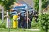 A line of police officers look for evidence at the scene of a car crash in London, Ontario on Monday, June 7, 2021. THE CANADIAN PRESS/Geoff Robins