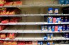 Empty shelves are seen at a supermarket in Paris, Monday, March 9, 2020. Global share markets have plunged as panicked investors fled to the safety of bonds and the yen to hedge the economic trauma of the coronavirus, while oil plunged more than 30 per cent after Saudi Arabia opened the taps in a price war with Russia.(AP Photo/Michel Euler)