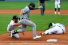 Detroit Tigers pitcher Daniel Norris, left, dives to tag out Chicago White Sox's Danny Mendick, center, as first baseman C.J. Cron (26) lies injured on the field in the fourth inning of a baseball game in Detroit, Monday, Aug. 10, 2020. (AP Photo/Paul Sancya)