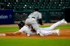 Chicago White Sox third baseman Yoan Moncada, top, tags out Detroit Tigers' Victor Reyes, bottom, at third base in the seventh inning of a baseball game in Detroit, Monday, Aug. 10, 2020. (AP Photo/Paul Sancya)