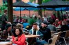 Members of the public are seen at a bar on Canal Street in Manchester's gay village, England, Saturday July 4, 2020. England is embarking on perhaps its biggest lockdown easing yet as pubs and restaurants have the right to reopen for the first time in more than three months. In addition to the reopening of much of the hospitality sector, couples can tie the knot once again, while many of those who have had enough of their lockdown hair can finally get a trim. (AP Photo/Jon Super)