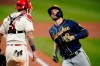 Milwaukee Brewers' Ryan Braun, right, scores past St. Louis Cardinals catcher Yadier Molina after hitting a solo home run during the fourth inning of a baseball game Saturday, Sept. 26, 2020, in St. Louis. (AP Photo/Jeff Roberson)