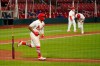 St. Louis Cardinals' Kolten Wong, left, tosses his bat after earning a bases loaded walk allowing Yadier Molina, right, to score the game-winning run during the ninth inning of a baseball game against the Kansas City Royals Wednesday, Aug. 26, 2020, in St. Louis. (AP Photo/Jeff Roberson)