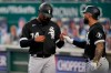 Chicago White Sox's Eloy Jimenez (74) is congratulated by Tim Anderson after scoring a run during the first inning of the team's baseball game against the Kansas City Royals at Kauffman Stadium in Kansas City, Mo., Friday, Sept. 4, 2020. (AP Photo/Orlin Wagner)