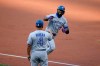 Toronto Blue Jays' Teoscar Hernandez, right, celebrates his home run with third base coach Luis Rivera (4) during the first inning of the team's baseball game against the Washington Nationals, Monday, July 27, 2020, in Washington. (AP Photo/Nick Wass)