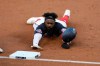 Washington Nationals' Josh Harrison slides into third base on a single by Eric Thames during the second inning of a baseball game against the Tampa Bay Rays, Monday, Sept. 7, 2020, in Washington. (AP Photo/Nick Wass)