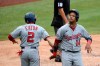 Washington Nationals' Starlin Castro (14) celebrates with Adam Eaton (2) after both scored on a double by Kurt Suzuki during the third inning of the team's baseball game against the Toronto Blue Jays, Thursday, July 30, 2020, in Washington. (AP Photo/Nick Wass)