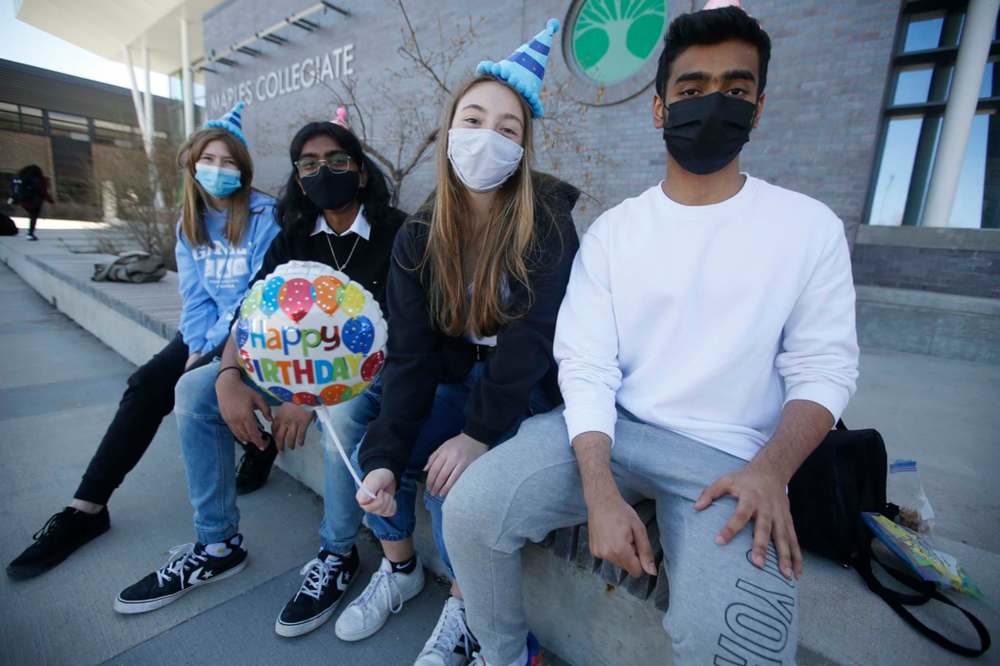JOHN WOODS / WINNIPEG FREE PRESS
Maples Collegiate students Jamie Anderson, Isaac Nimmagadda, Rebecca Cabral and Harshveer Multani are outside the school in Winnipeg Monday. Cabral celebrated her 17th birthday with her friends before schools closed due to lockdown.